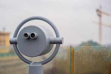 closeup coin operated binoculars overlooking after rain