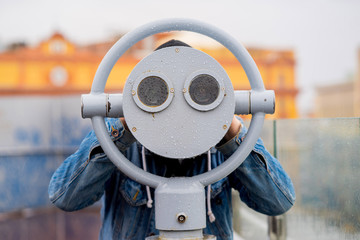 fun ideas. man looks through his binoculars on the lookout closeup