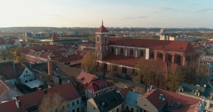 Aerial, Course lock drone shot around Kaunas Cathedral Basilica and Town Hall above Vilnius street, spring, 4K,Kaunas, Lithuania