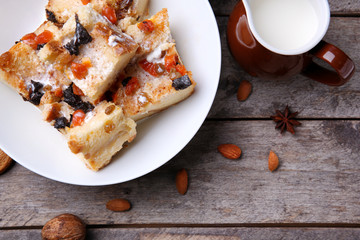 Delicious bread pudding with nuts on table