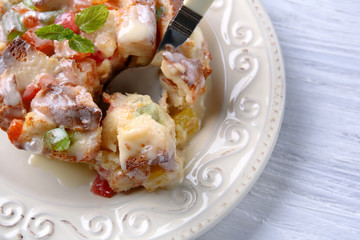Delicious bread pudding with candied fruits on table