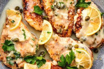 Delicious chicken Italian piccata with lemon, closeup
