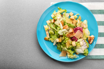 Plate with chicken salad on table