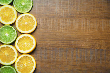 Fototapeta na wymiar Sliced citrus fruits on wooden background
