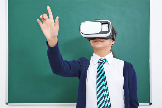 Schoolgirl With Virtual Reality Glasses In Classroom