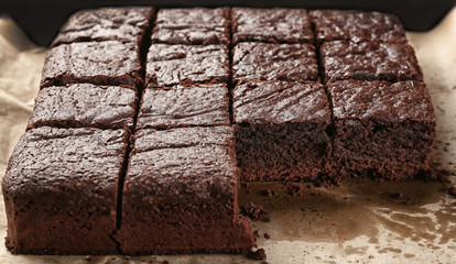 Baking tray with delicious chocolate cake on wooden table