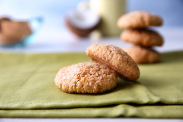 Delicious coconut cookies on green napkin against blurred background