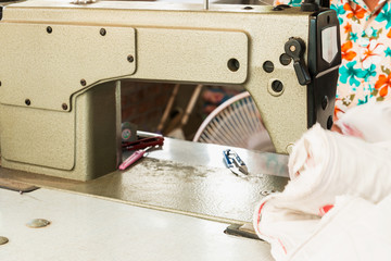 Industrial sewing machines with workers being sewn.