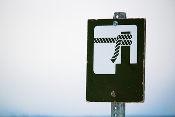 Boat mooring sign with a foggy background