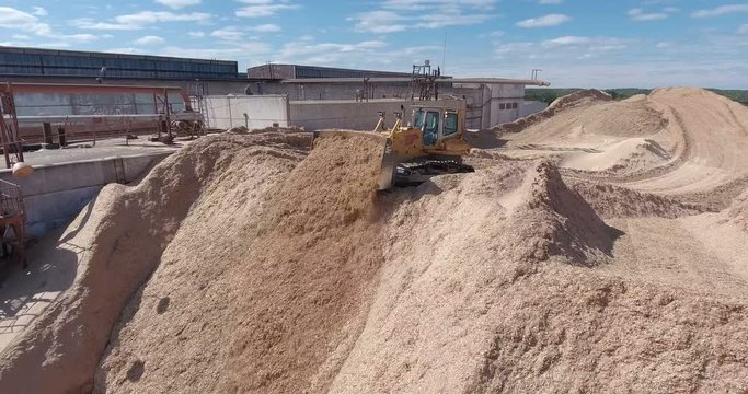 A tractor is throwing down sawdust