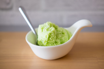 Lime ice cream in a white bowl