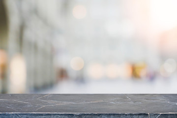 Stone table top and blurred shopping plaza background - can used for display or montage your products.