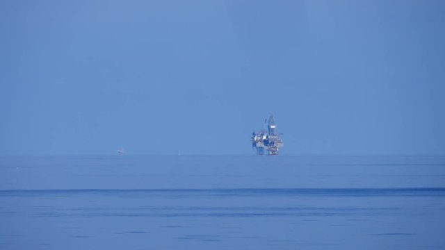 Offshore Jack up drilling rig in the middle of the ocean on sunny day
