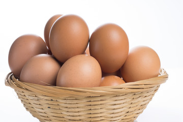 Eggs in the basket isolated on white background.
