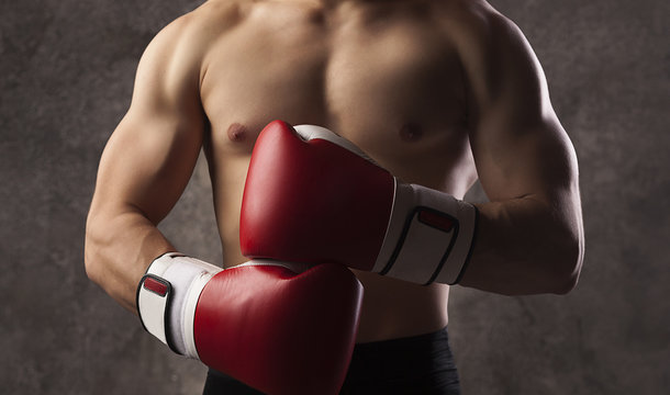 Young muscular man boxer, boxing gloves
