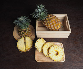 Fototapeta na wymiar pineapple and pineapple slide in wood box 