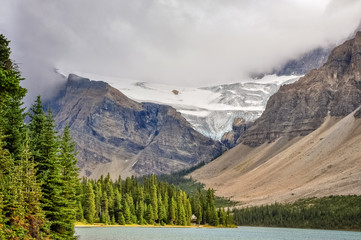 A cloud formation is going down the mountain at Bow lake and glacier in Banff National Park, Alberta, Canada.