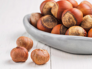 hazelnut on white wooden background