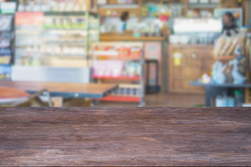 Selected focus empty brown wooden table and Coffee shop or restaurant blur background with bokeh image. for your photomontage or product display