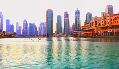 Dubai promenade singing fountains on the background of architecture, sunset April 7, 2014