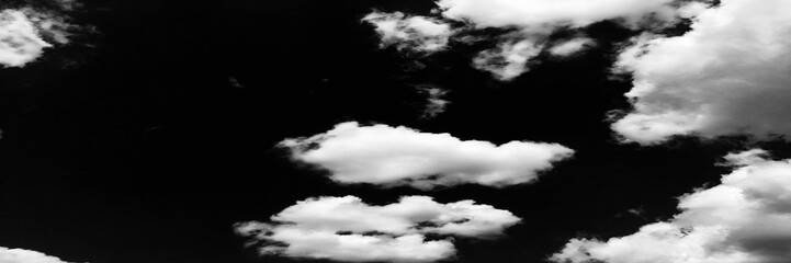 Isolated clouds over black.