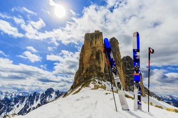 Rollo Mountaineer backcountry ski equipment in spring snow.  In background blue cloudy sky and shiny sun and Tre Cime, Drei Zinnen in South Tirol, Dolomites, Italy. Adventure winter extreme sport. © Gorilla