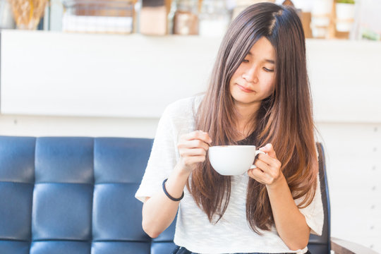 Women with white cup of hot coffee