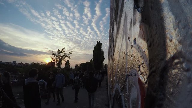 Berlin Wall Section With Graffiti At Mauerpark. Time Lapse With People  Passing By At Sunset