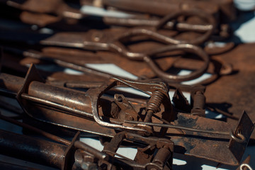 macro old rusty metal parts on counter in sunday flea market. Antique bazaar