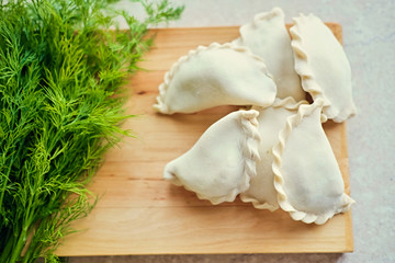 Making Russian dumplings with parsley.
