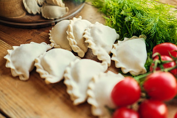 Frozen dumplings with cherry tomatoes and parsley.