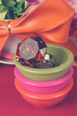 topaz ring in a bowl with colorful artificial flower