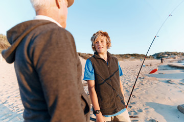 Fototapeta premium Senior man fishing with his grandson