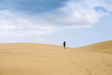 Fototapeta na wymiar Lonely man crossing the desert