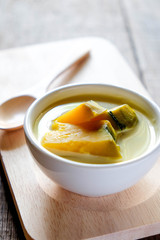 Thai style dessert, pumpkin sliced in sweet coconut milk.