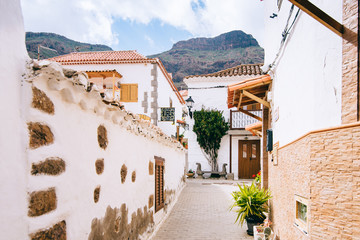 Fototapeta na wymiar Cozy village with white houses and tiles on the background of mountains in the Canary Islands