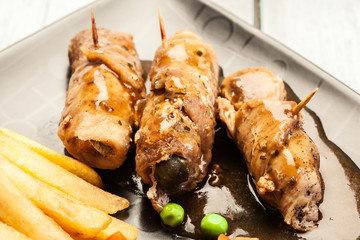 Pork rolls with french fries with vegetable