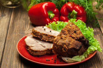 Roasted pork neck with spices on cutting board