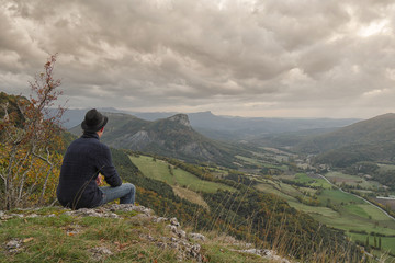 Fototapeta premium young man looking the mountain at sunset