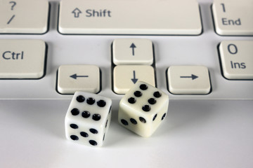 Dice on computer keyboard. Conceptbusiness risk, chance.