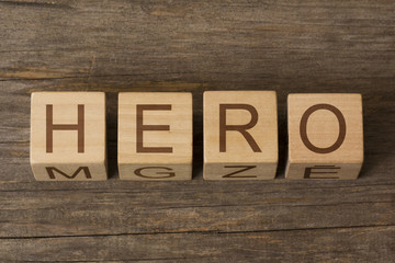 Fototapeta premium word hero written on cubes on wooden background