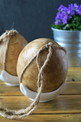 Easter eggs decorated by decoupage technique on wooden desk.