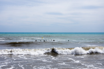 A group of surfers waiting for a wave on the Mediterranean coast