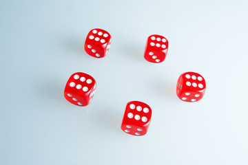 Red dice on the glass. Five dice with the value of "six". Successful throw. Five red dice are on the table
