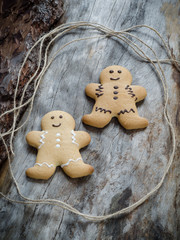 Happy gingerbread people on aged wood