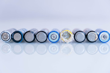old battery was leaking, hazardous waste. abstract background of colorful batteries. . Alkaline battery aa size. Group of used disposable drain batteries of various size ready for recycling.