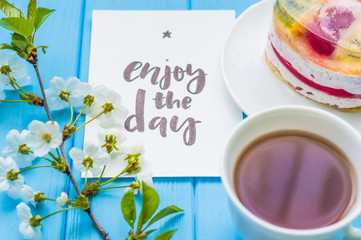 Still life with cup of tea and cake on the wooden background
