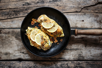 Two roasted chicken rolls lying on grill pan. Top view concept image of cooking food