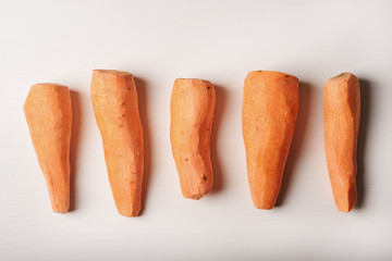 peeled carrots, five pieces lying on the whiteboard