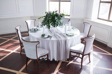 Wedding served table setting of palm tree leaves